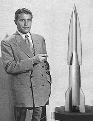 Wernher von Braun pointing at a model of an A-9 Rocket