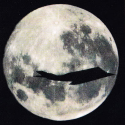 f-117 flying past the moon